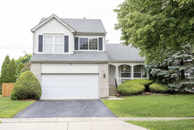 15 Brittany Ct, South Elgin, IL 60177 - traditional-style house with driveway, a front lawn, a shingled roof, and brick siding