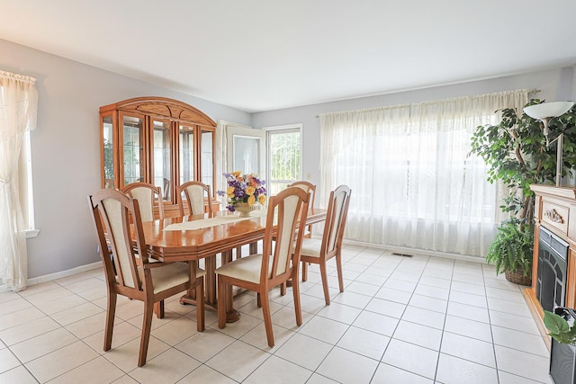 15 Brittany Ct, South Elgin, IL 60177 - dining space featuring light tile patterned floors, a fireplace, and baseboards