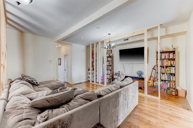 2248 W 50th Pl, Chicago, IL 60609 - living room featuring light wood finished floors, a chandelier, and baseboards