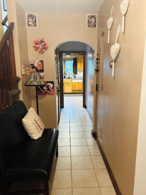 1607 183rd St, Homewood, IL 60430 - hall with arched walkways and light tile patterned flooring