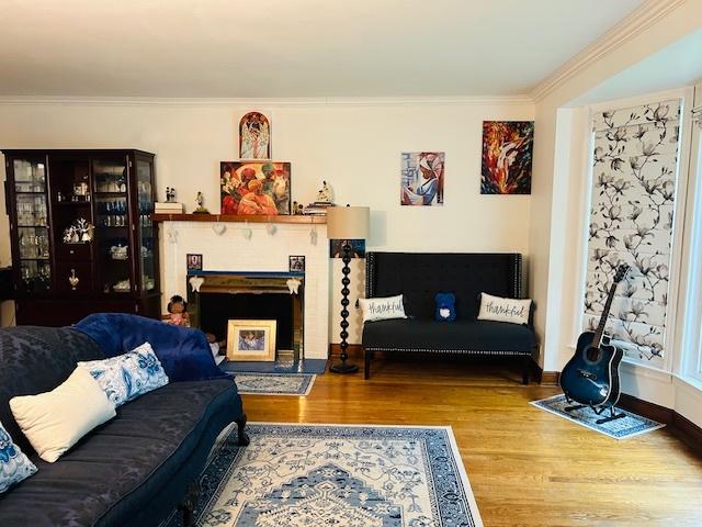 1607 183rd St, Homewood, IL 60430 - living room with wood finished floors, crown molding, and a fireplace