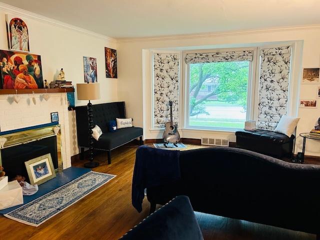 1607 183rd St, Homewood, IL 60430 - living room featuring crown molding, wood finished floors, and a fireplace