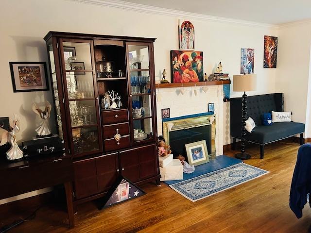 1607 183rd St, Homewood, IL 60430 - living room with crown molding, wood finished floors, and a fireplace