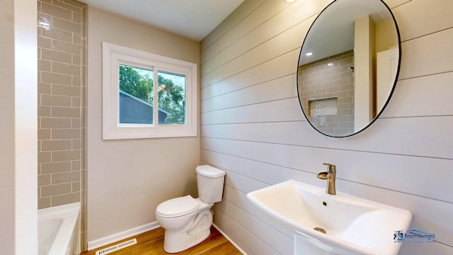 1510 Hillside Ln, Mchenry, IL 60051 - full bathroom featuring toilet, wood finished floors, a sink, and washtub / shower combination