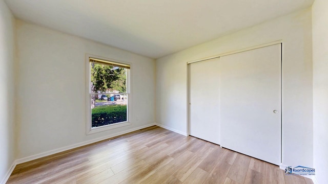 1510 Hillside Ln, Mchenry, IL 60051 - unfurnished bedroom with light wood finished floors, a closet, and baseboards