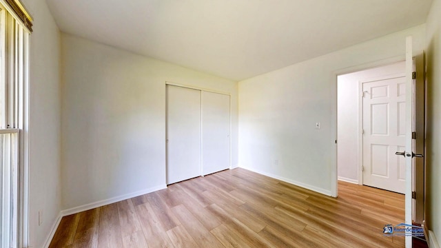 1510 Hillside Ln, Mchenry, IL 60051 - unfurnished bedroom with light wood-style floors, baseboards, and a closet