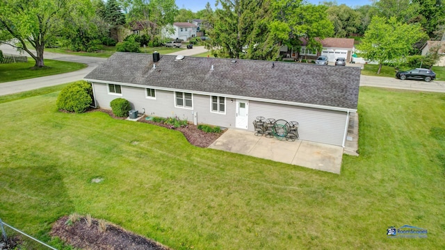 1510 Hillside Ln, Mchenry, IL 60051 - rear view of house with a shingled roof, a lawn, and a patio