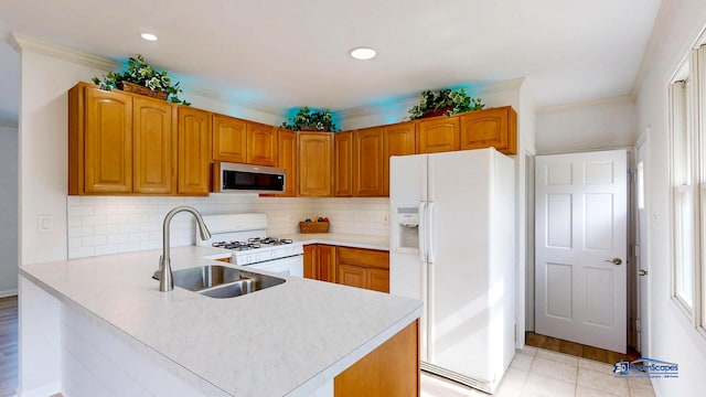 1510 Hillside Ln, Mchenry, IL 60051 - kitchen with white appliances, a sink, a peninsula, light countertops, and recessed lighting