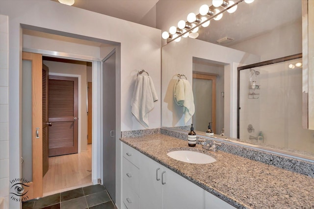 360 W Illinois St Unit 114, Chicago, IL 60654 - full bathroom featuring vanity, a shower with shower door, and tile patterned flooring