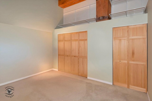 360 W Illinois St Unit 114, Chicago, IL 60654 - unfurnished bedroom featuring carpet, baseboards, and vaulted ceiling