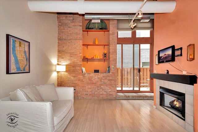 360 W Illinois St Unit 114, Chicago, IL 60654 - living room featuring hardwood / wood-style flooring and a tile fireplace
