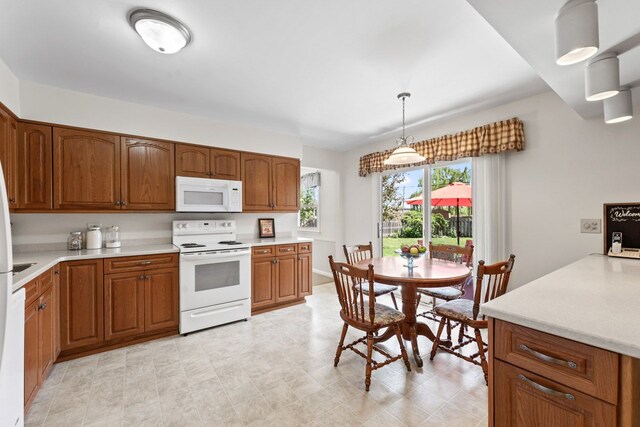 1805 E Tano Ln, Mount Prospect, IL 60056 - kitchen featuring white appliances, brown cabinets, light countertops, pendant lighting, and light floors