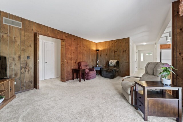1805 E Tano Ln, Mount Prospect, IL 60056 - living room featuring wood walls and light colored carpet