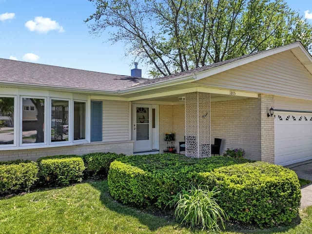 1805 E Tano Ln, Mount Prospect, IL 60056 - ranch-style home featuring brick siding, a garage, a chimney, a shingled roof, and a front lawn