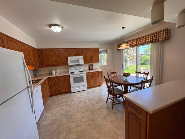 1805 E Tano Ln, Mount Prospect, IL 60056 - kitchen featuring white appliances, brown cabinetry, light countertops, and decorative light fixtures