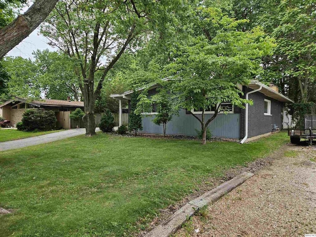 612 Edgewood Dr, Quincy, IL 62301 - obstructed view of property with a front lawn, brick siding, and a chimney