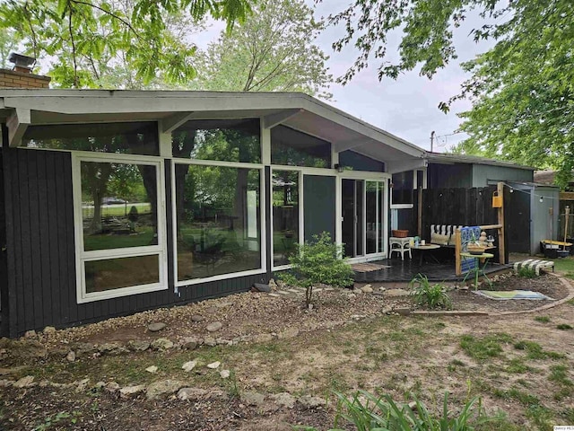 612 Edgewood Dr, Quincy, IL 62301 - rear view of house featuring a sunroom