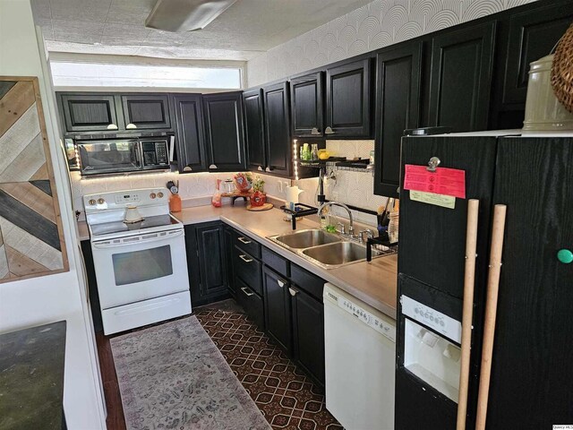 612 Edgewood Dr, Quincy, IL 62301 - kitchen featuring black appliances, a sink, dark cabinetry, and light countertops
