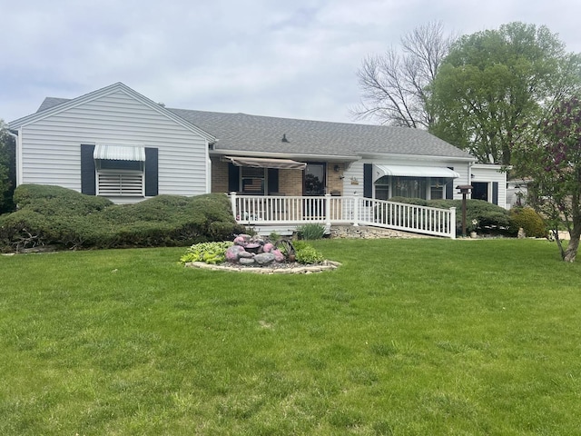 204 Elm St, Morrison, IL 61270 - ranch-style home with a front yard, roof with shingles, brick siding, and a porch