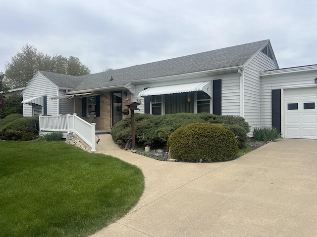 204 Elm St, Morrison, IL 61270 - single story home with a front yard, roof with shingles, and a garage