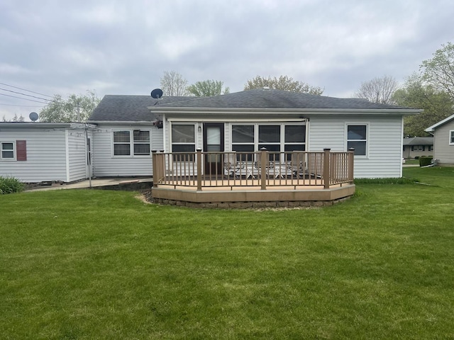 204 Elm St, Morrison, IL 61270 - back of house with roof with shingles, a wooden deck, and a lawn