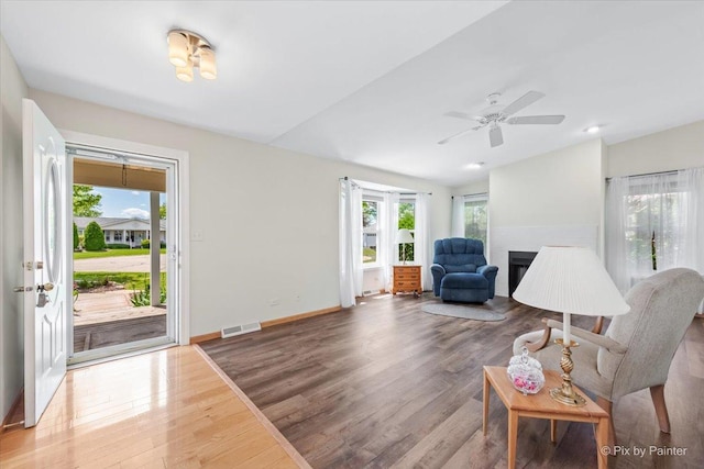 14 Devonshire Ct, Grayslake, IL 60030 - living room featuring wood finished floors, a fireplace, a ceiling fan, baseboards, and vaulted ceiling