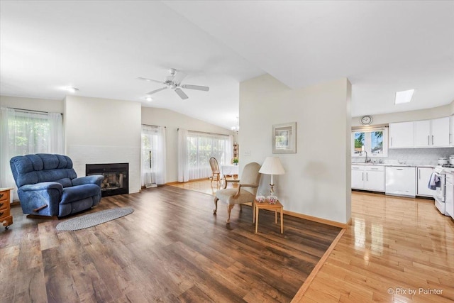 14 Devonshire Ct, Grayslake, IL 60030 - living area with light wood finished floors, a fireplace, vaulted ceiling, ceiling fan, and baseboards