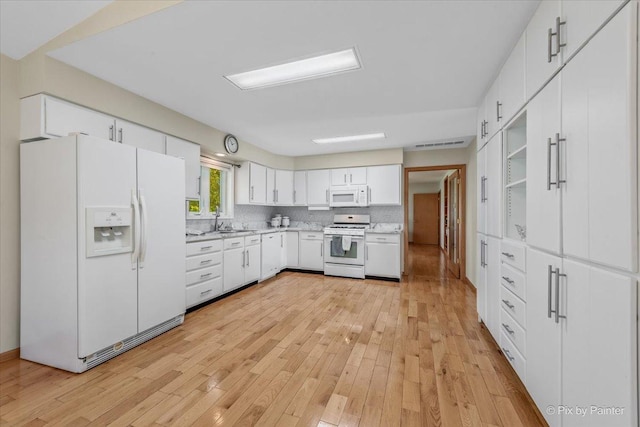 14 Devonshire Ct, Grayslake, IL 60030 - kitchen with white appliances, light countertops, light wood-style floors, a sink, and white cabinetry