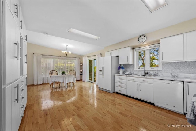 14 Devonshire Ct, Grayslake, IL 60030 - kitchen featuring white appliances, a chandelier, a sink, light countertops, and white cabinetry