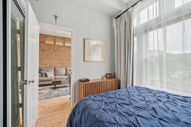 1423 N Ashland Ave Unit 201, Chicago, IL 60622 - bedroom with wood finished floors and brick wall