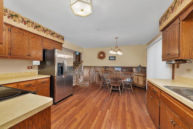 25408 W Willow Dr, Plainfield, IL 60544 - kitchen featuring stainless steel fridge with ice dispenser, a chandelier, wood finished floors, light countertops, and brown cabinets