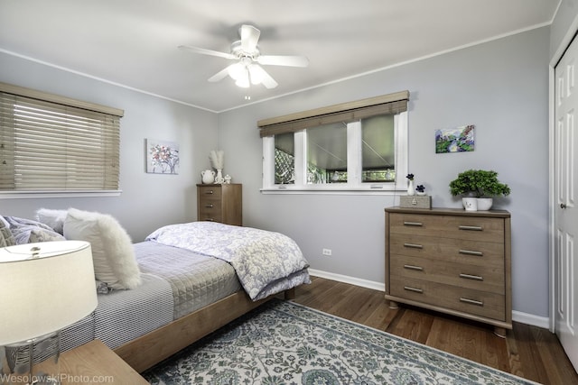 5036 Ozark Ave, Norridge, IL 60706 - bedroom featuring baseboards, dark wood-style floors, a closet, ornamental molding, and a ceiling fan