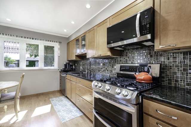 5036 Ozark Ave, Norridge, IL 60706 - kitchen featuring stainless steel appliances, a sink, crown molding, light wood-type flooring, and decorative backsplash