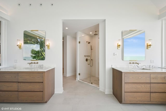 90 Kedzie St, Evanston, IL 60202 - full bathroom featuring a stall shower, two vanities, tile patterned flooring, and baseboards