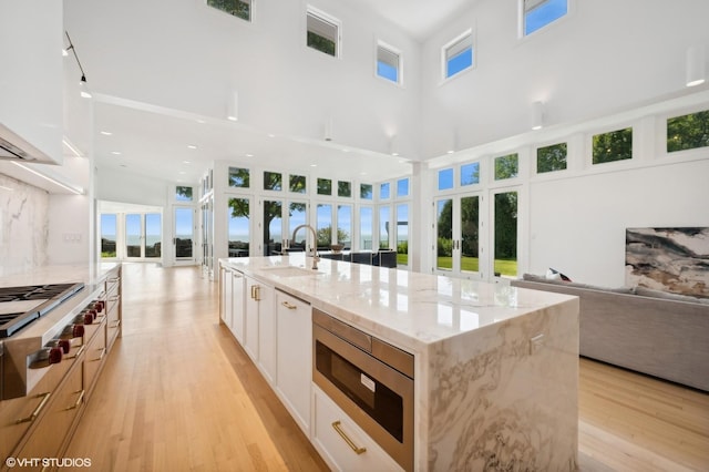 90 Kedzie St, Evanston, IL 60202 - kitchen with french doors, open floor plan, a sink, stainless steel appliances, and a towering ceiling