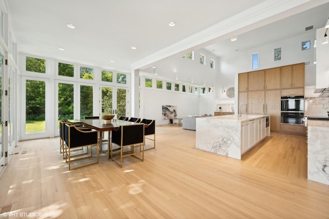 90 Kedzie St, Evanston, IL 60202 - dining room featuring light wood-style flooring, a high ceiling, and recessed lighting