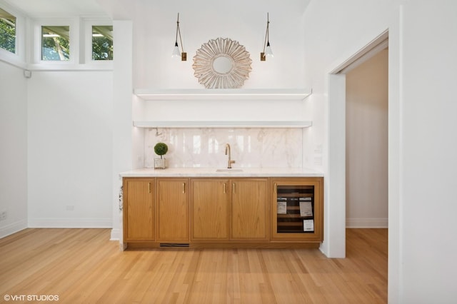 90 Kedzie St, Evanston, IL 60202 - indoor wet bar featuring light wood-style floors, baseboards, and tasteful backsplash