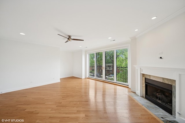 3560 S Giles Ave Unit 2, Chicago, IL 60653 - unfurnished living room featuring a tile fireplace, a ceiling fan, light wood finished floors, ornamental molding, and recessed lighting