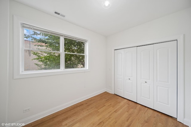 3560 S Giles Ave Unit 2, Chicago, IL 60653 - unfurnished bedroom with baseboards, light wood-style flooring, and a closet