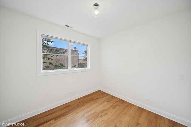 3560 S Giles Ave Unit 2, Chicago, IL 60653 - unfurnished room with baseboards and light wood finished floors