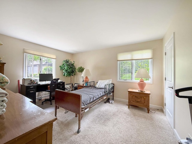 258 Brookside Ln Unit B, Willowbrook, IL 60527 - bedroom with an office area, light colored carpet, and baseboards