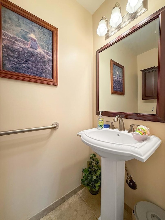 258 Brookside Ln Unit B, Willowbrook, IL 60527 - half bath featuring baseboards, tile patterned floors, a sink, and toilet