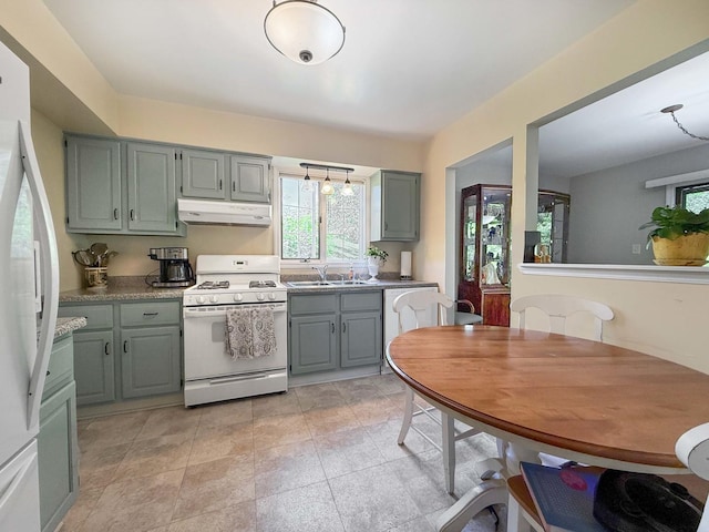 258 Brookside Ln Unit B, Willowbrook, IL 60527 - kitchen with white appliances, under cabinet range hood, a sink, and plenty of natural light