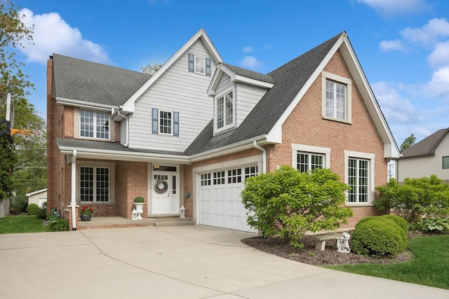 5417 Lawn Ave, Western Springs, IL 60558 - view of front of property featuring brick siding, driveway, covered porch, and roof with shingles