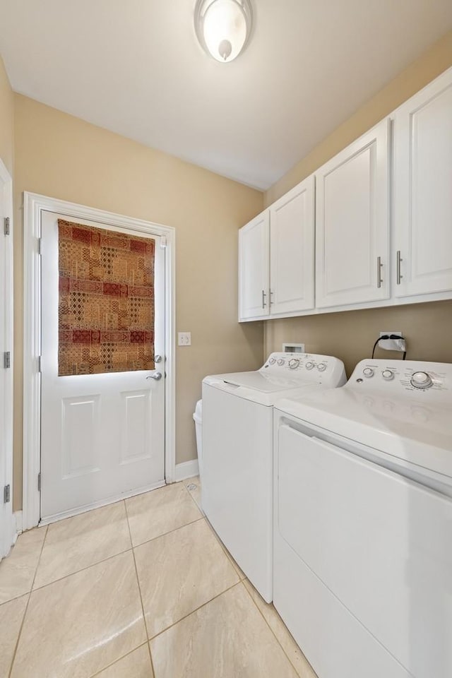 5417 Lawn Ave, Western Springs, IL 60558 - washroom with cabinet space, washing machine and dryer, light tile patterned flooring, and baseboards
