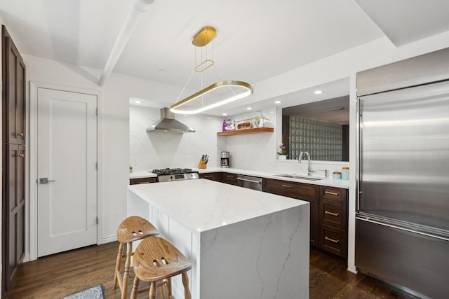 727 S Dearborn St Unit 911, Chicago, IL 60605 - kitchen with stainless steel appliances, wall chimney range hood, dark wood-style flooring, a breakfast bar, and a kitchen island