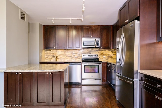 4250 N Marine Dr Unit 1628, Chicago, IL 60613 - kitchen with stainless steel appliances, dark wood-style flooring, decorative backsplash, light stone counters, and dark brown cabinets