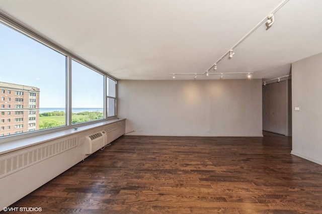 4250 N Marine Dr Unit 1628, Chicago, IL 60613 - unfurnished room featuring track lighting, wood finished floors, radiator heating unit, and a wall unit AC