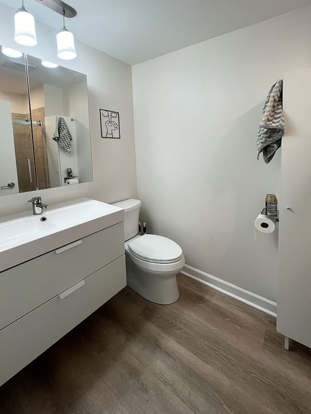 985 W Ct Unit D, Naperville, IL 60563 - full bathroom with wood finished floors, toilet, vanity, a shower, and baseboards