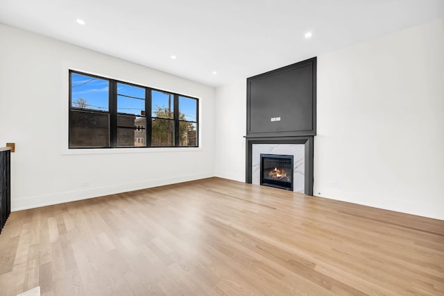 3903 N Drake Ave, Chicago, IL 60618 - unfurnished living room with wood finished floors, a large fireplace, baseboards, and recessed lighting